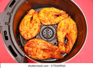 Marinated Half Cooked Spicy Salmon Pieces On A Air Fryer Basket 