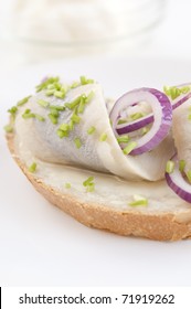 Marinated Herring Filet With Chives And Onion On White Plate