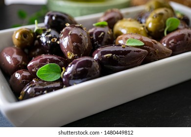 Marinated Kalamata Olives In White 
Ceramic Tray. Top View. Close Up