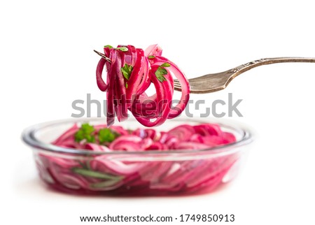 Marinated  pickled red onion rings on fork isolated on white 
