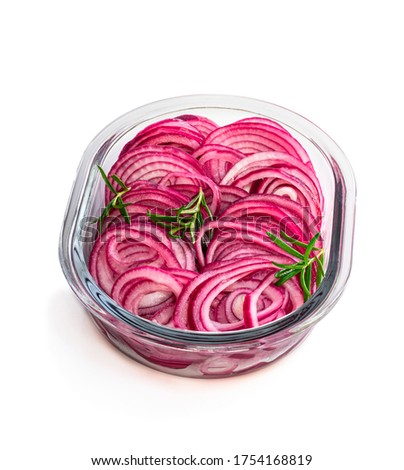Marinated  pickled red onion rings in glass bowl isolated on white 