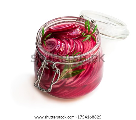 Marinated  pickled red onion rings in glass jar isolated on white 