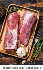 Marinated Pork Tenderloin Meat Steak With Thyme. Dark Wooden Background. Top View