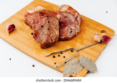 Marinated Pork Tenderloin With Spices. On A Wooden Board