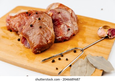 Marinated Pork Tenderloin With Spices. On A Wooden Board