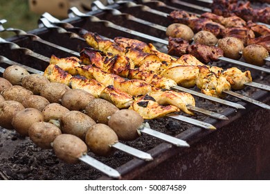 Marinated shashlik preparing on a barbecue grill over charcoal. Shashlik or Shish kebab popular in Eastern Europe. Shashlyk (skewered meat) was originally made of lamb. Roast Beef Kebabs On BBQ Grill.
