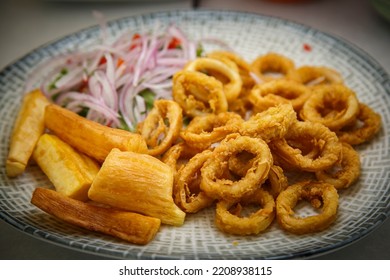 Marinated Squid Cracklings With A Secret Sauce, Accompanied By Yucca And Sarsa Criolla.