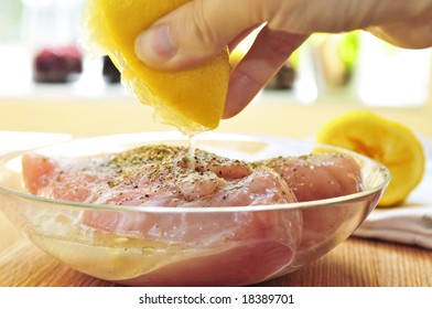 Marinating Raw Chicken Breasts In Lemon Juice And Herbs