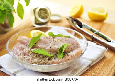 Marinating Raw Chicken Breasts In Lemon Juice And Herbs