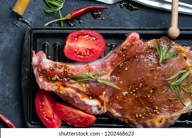 Marinating raw lamb chops with spices, honey and tomato on grill pan, close up - Powered by Shutterstock