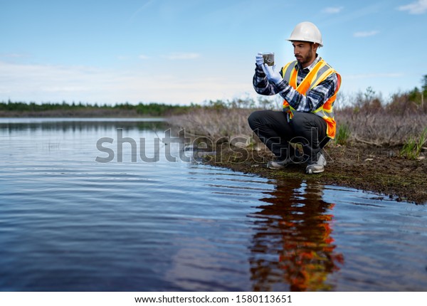 Marine biologist analysing water test results and\
algea samples