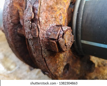 Marine corrosion in the form of general attack on carbon steel flanges or metal equipment on pier. Area most affected is wet and dry zones. Severe corrosion was evidenced by corrosion product layers. - Shutterstock ID 1382304863