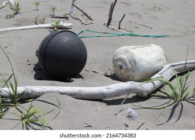 Marine Debris Washed Up On A Sandy Beach