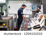 Marine engineer officer in engine control room ECR. Seamen