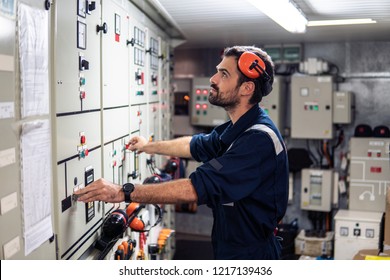 Marine Engineer Officer In Engine Control Room ECR. Seamen's Work. He Starts Or Stops Main Engine Of Ship