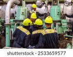 The marine engineer officer gives clear instructions to the engine crew before starting maintenance on the ship’s main engine. The team listens attentively, ensuring a safe and efficient operation.