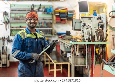Marine engineer working inside the engine room of a commercial cargo vessel, surrounded by ship machinery and industrial equipment.