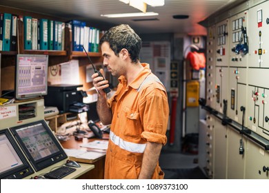 Marine Engineer Working On Radio Communication At Engine Control Room ECR. Vessel Communication With VHF And UHF Walkie-talkie Radio