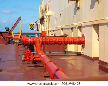 Marine fire extinguishing system with red pipes on a dry cargo ship. Fire safety concept