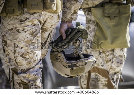 Marine helmet held by the soldier.