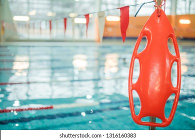 Marine lifebuoy on fence, near swimming indoor pool - Powered by Shutterstock