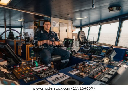 Marine navigational officer during navigational watch on Bridge . Work at sea