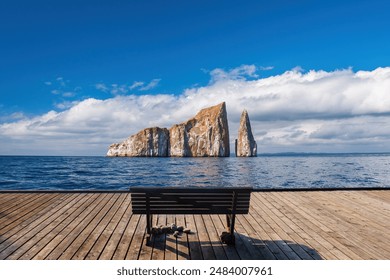 Marine pier. Wooden platform with bench. Pier overlooking ocean. Sea cliffs. Picturesque nautical landscape. Wooden pier under blue sky. Bench for relaxation on seashore. Marine nature - Powered by Shutterstock