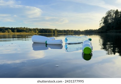 Marine plastic pollution. Plastic waste in lake. Microplastics groundwater poisoning. Ocean pollution and marine debris. Litter such as plastic from food in water of river. Plastic marine debris.   - Powered by Shutterstock