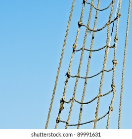 Marine Rope Ladder At Pirate Ship. Sea Hemp Ropes On The Old Nautical Vessel. Ladder Upstairs On The Mast.