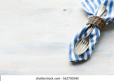 Marine Themed Table Setting With Sea Star, Vintage Silverware And Napkin On Wooden Table