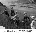 Marine wounded being carried from the front lines to a forward aid station in Korea. Vintage black and white photography.