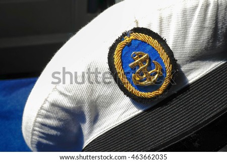 Marine's hat or Naval cap with a visor. selective focus on the anchor logo. Sunlight, Window light.