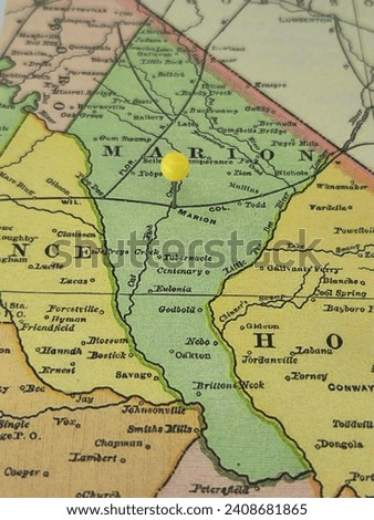 Marion County, South Carolina marked by a yellow tack on a colorful vintage map. The county seat is located in the city of Marion, SC.