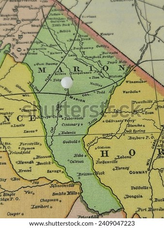 Marion County, South Carolina marked by a white tack on a colorful vintage map. The county seat is located in the city of Marion, SC.