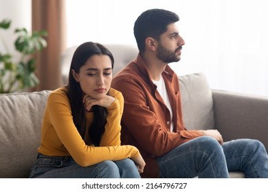 Marital Crisis. Unhappy Arabic Couple Sitting On Couch At Home, Having Relationship Problems. Bad Marriage, Breakup Concept. Selective Focus On Frustrated Woman - Shutterstock ID 2164796727