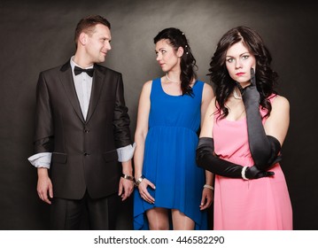Marital infidelity concept. Love triangle two women one man passion of love hate. Mistress betrayal within the family. Black background.
