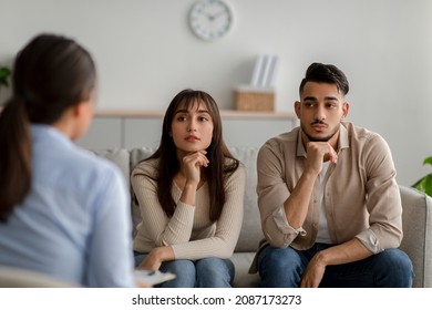 Marital psychotherapy. Sad arab spouses with relationship problems sitting at therapy session with psychologist, listening advices from professional counselor - Powered by Shutterstock