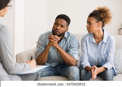 Marital Therapy. Black Couple Listening To Counselor's Advice Sitting On Couch In Office.
