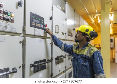 Maritime engineer adjusting parameters on a power generator control panel during vessel operations at sea.