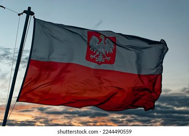 Maritime Flag of Poland, Polish maritime flag, Polish flag in the wind, evening sky background. The currently valid flag in civil shipping. - Powered by Shutterstock