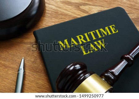 Maritime law black book and wooden gavel.
