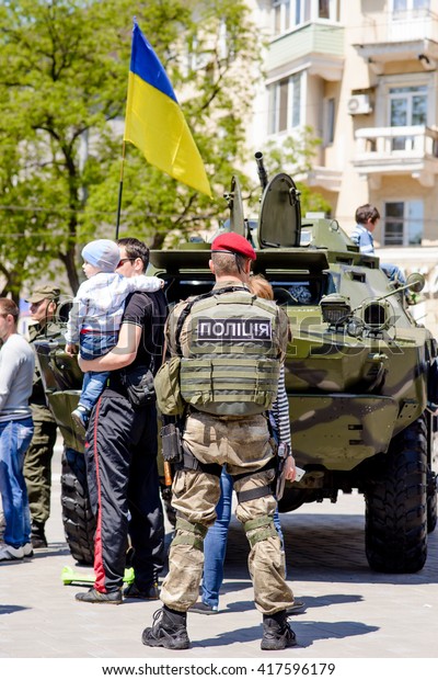 MARIUPOL MAY 9 : Events to\
commemorate the anniversary of the Victory in World War II.\
Ukrainian policment near military equipment , May 9 2016 Mariupol,\
Ukraine