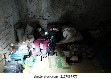 MARIUPOL, UKRAINE - 5 MARCH 2022: Ukrainian kid, childrens takes shelter in her basement during bombardment by Russian aviation, artillery.