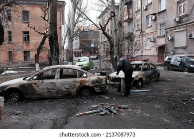 MARIUPOL, UKRAINE - March. 5, 2022: War of Russia against Ukraine. Residential Building and civil cars damaged by Russian army aircraft, artellery bombs against civil in the Ukrainian city Mariupol.