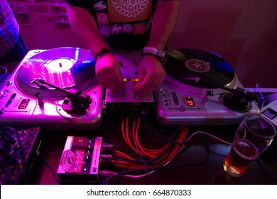 MARIUPOL,UKRAINE-2 JULY,2013:Hip Hop Party Dj Mixing Music Tracks On Sound Mixer.Professional Audio Mixing Hardware.Dj Setup For Scratch.Hip Hop Dj Mixing Live Set In Party Bar.Concert Magenta Lights