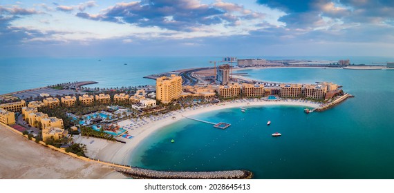 Marjan Island seafront reclaimed land artificial island in emirate of Ras al Khaimah in the United Arab Emirates aerial view at sunrise - Shutterstock ID 2028645413