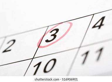 Mark the date number third. The third day of the month is marked with a red circle. Focus point on the marked number.