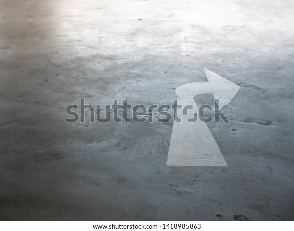 Mark the right turn on road\
surface in the parking lot. Turn right symbol or icon. Blur\
concept.