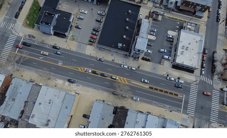 Marked intersection flow at Oregon Ave and S 10th St captures multi lane traffic patterns framed by mixed residential, commercial edges. Painted lanes, asphalt texture, crisp sunlight, Philly, PA. USA