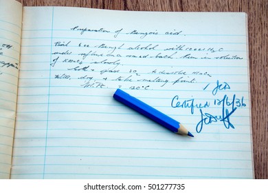 Marked schoolwork dated 1936 with blue marking pencil added.